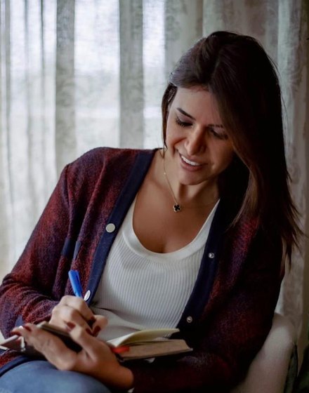 Hanaa Ahmed writing in a notebook